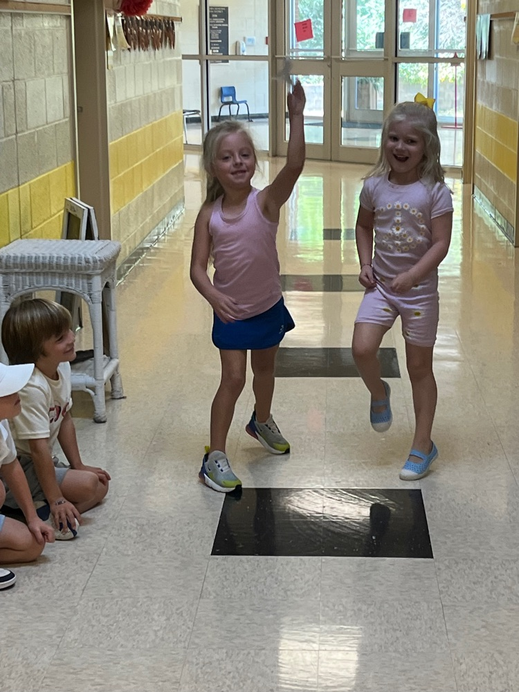 Students fly paper airplanes. 
